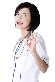Young female doctor or nurse gesturing perfect