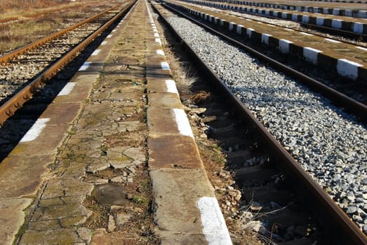 Railway station platforms and lines close-up, perspective