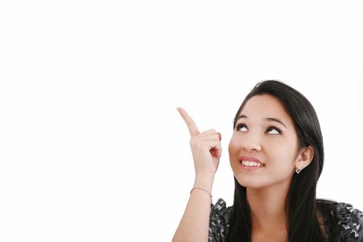 Attractive young woman points to something above her head