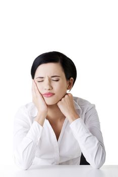 Young woman in pain is having toothache isolated on white