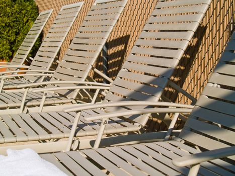 Lounge chairs by the pool on a sunny day