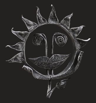 Metal forged isolated sunflower with face and smile