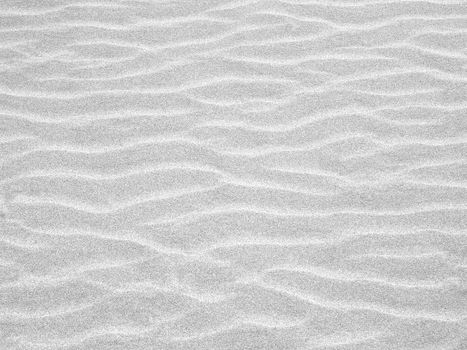 Abstract background of white sand ripples at the beach