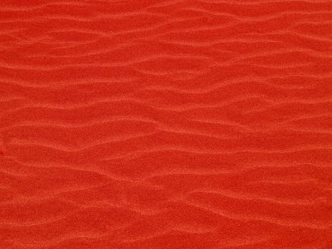 Abstract background of red sand ripples at the beach