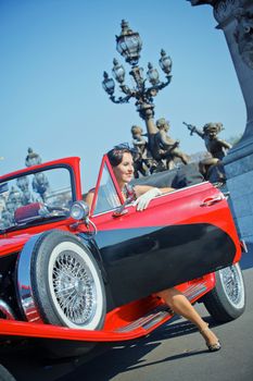 Romantic in Paris. Young happy woman in retro-style travel in a car in Paris