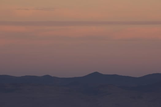 Sunset sky with mountain silhouettes