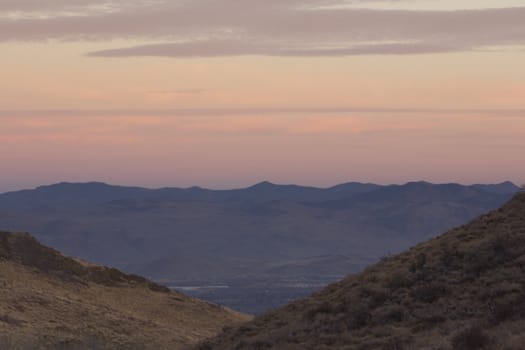 Sunset sky with mountain silhouettes