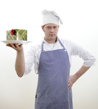 chief cook with a gift on a plate