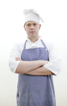 Portrait of handsome chief cook with arms crossed