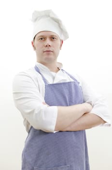 Portrait of handsome chief cook with arms crossed