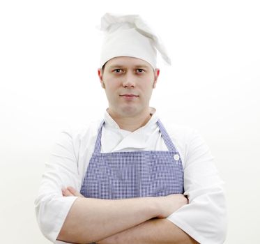 Portrait of handsome chief cook with arms crossed