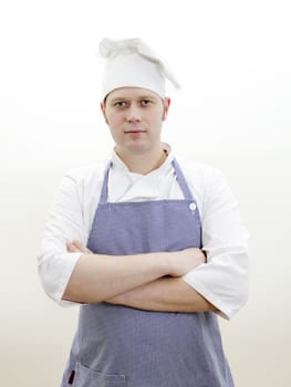 Portrait of handsome chief cook with arms crossed