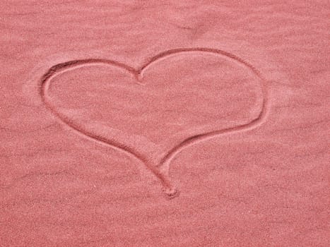 Red Heart in the Sand on a Sunny Day