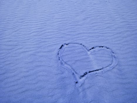 Blue Heart in the Sand on a Sunny Day