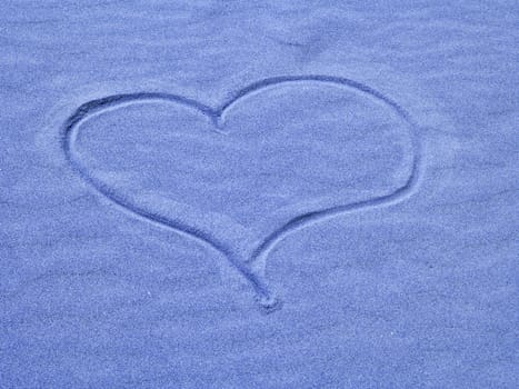 Blue Heart in the Sand on a Sunny Day