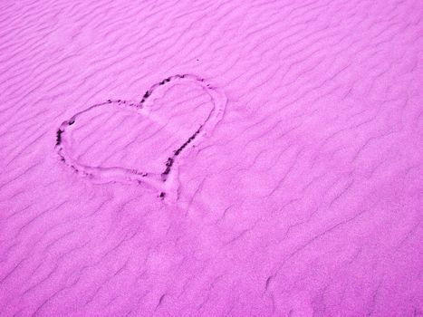 Pink Heart in the Sand on a Sunny Day