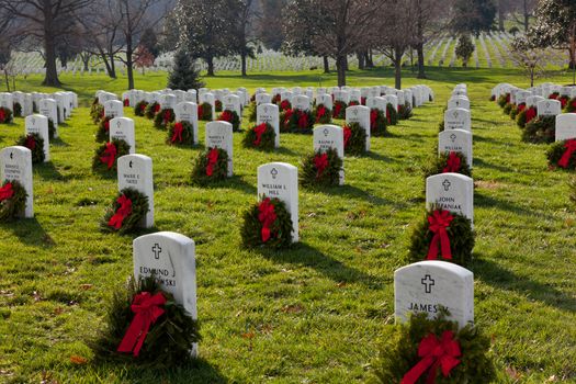 ARLINGTON, VA - DECEMBER 18: Christmas wreaths on gravestones in Arlington National Cemetery on December 18, 2011. The wreathes have been donated each year since 1992.