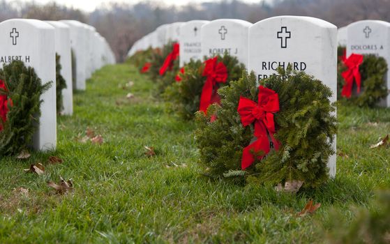 ARLINGTON, VA - DECEMBER 18: Christmas wreaths on gravestones in Arlington National Cemetery on December 18, 2011. The wreathes have been donated each year since 1992.