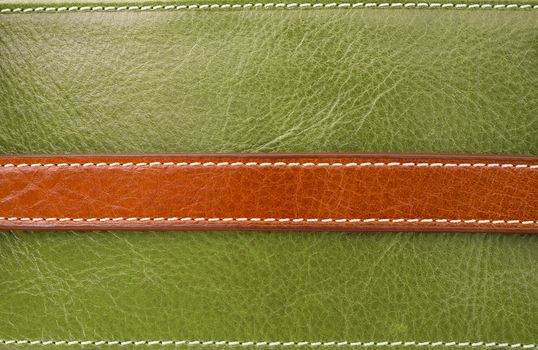 Texture of brown on green leather and Stitched with white thread