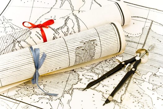 Olda Maps in rolls with ribbons and compass