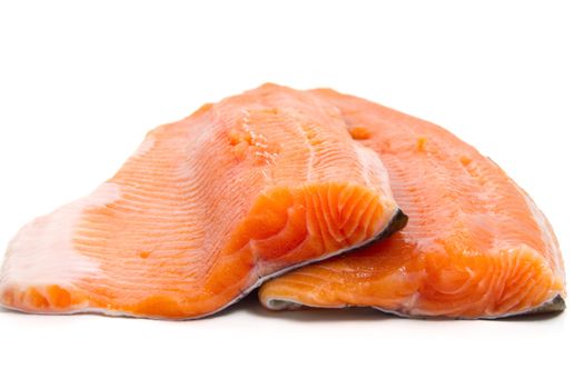 detail of salmon trout fillets over white background