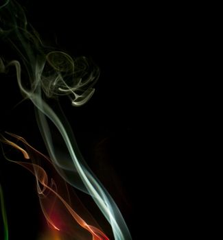 colorful background of smoke trails lit by colored lights