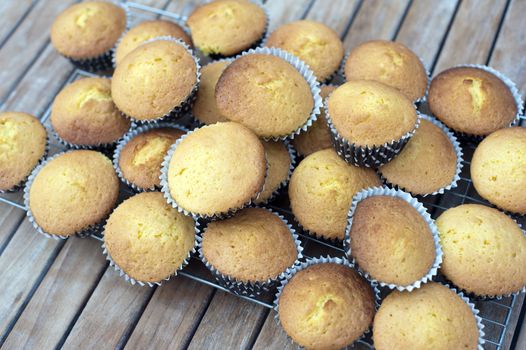 a stack of fresh baked party cakes on a cooling tray