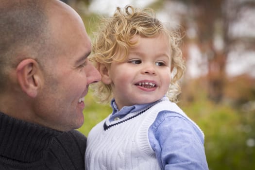 Handsome Father and Son Having Fun in the Park.