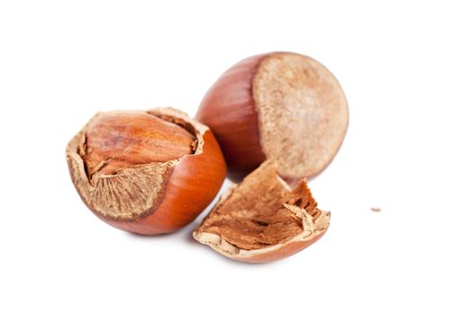 Closeup view of hazelnuts over white background