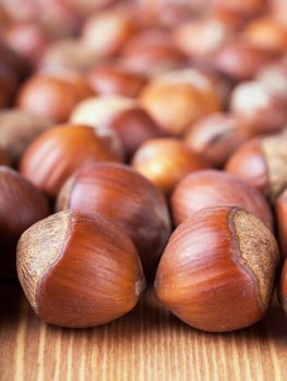 Closeup view of hazelnuts on a wooden table