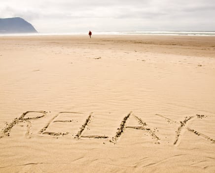 Relax Written in the Sand on a Sunny Day