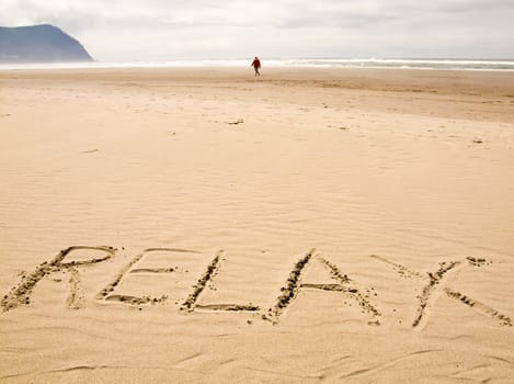 Relax Written in the Sand on a Sunny Day