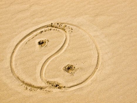 Yin and Yang Symbol Written in the Sand on a Sunny Day