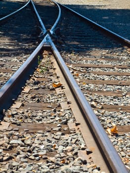 Old Railroad Tracks at a Junction on a Sunny Day