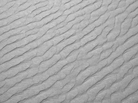 Abstract background of white sand ripples at the beach 