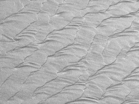 Abstract background of white sand ripples at the beach 