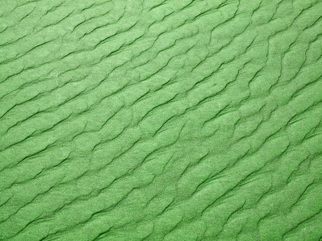 Abstract background of green sand ripples at the beach 