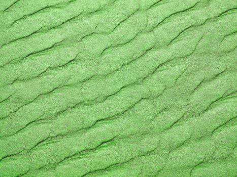 Abstract background of green sand ripples at the beach 