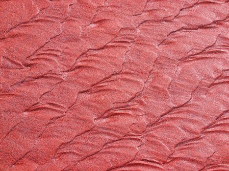 Abstract background of red sand ripples at the beach 