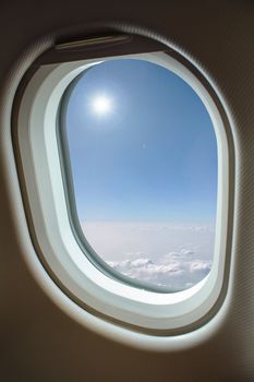 View above clouds from window with airplane