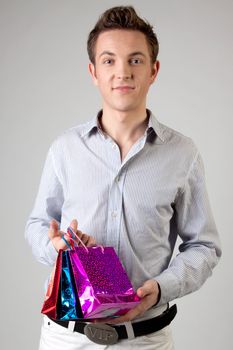 Portrait of a young man in formal attire with a New Year's gifts in their hands