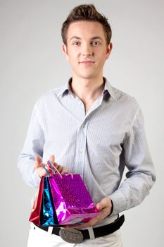 Portrait of a young man in formal attire with a New Year's gifts in their hands