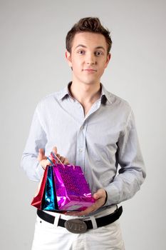 Portrait of a young man in formal attire with a New Year's gifts in their hands