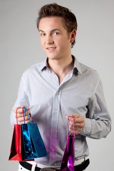 Portrait of a young man in formal attire with a New Year's gifts in their hands