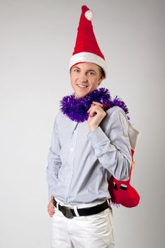 Portrait of a young man in formal attire with a New Year's gifts in their hands