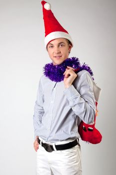 Portrait of a young man in formal attire with a New Year's gifts in their hands