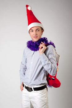 Portrait of a young man in formal attire with a New Year's gifts in their hands