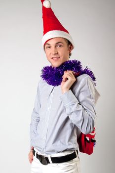 Portrait of a young man in formal attire with a New Year's gifts in their hands