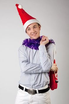 Portrait of a young man in formal attire with a New Year's gifts in their hands