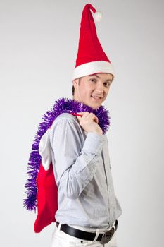 Portrait of a young man in formal attire with a New Year's gifts in their hands